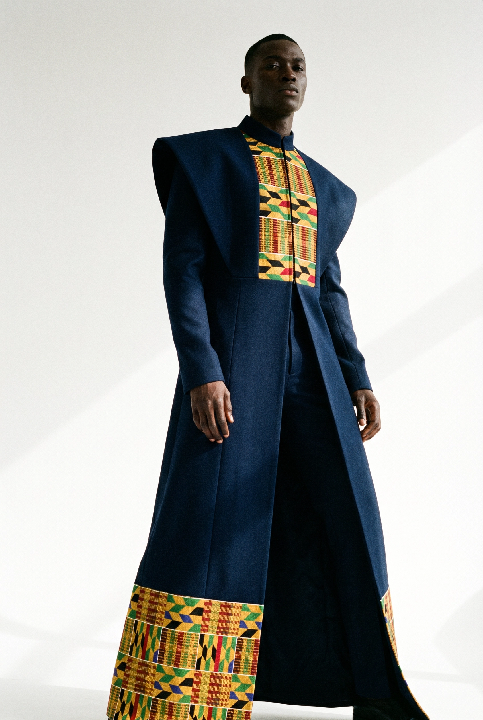 Navy Kente Coat — structured navy coat with kente panel detailing